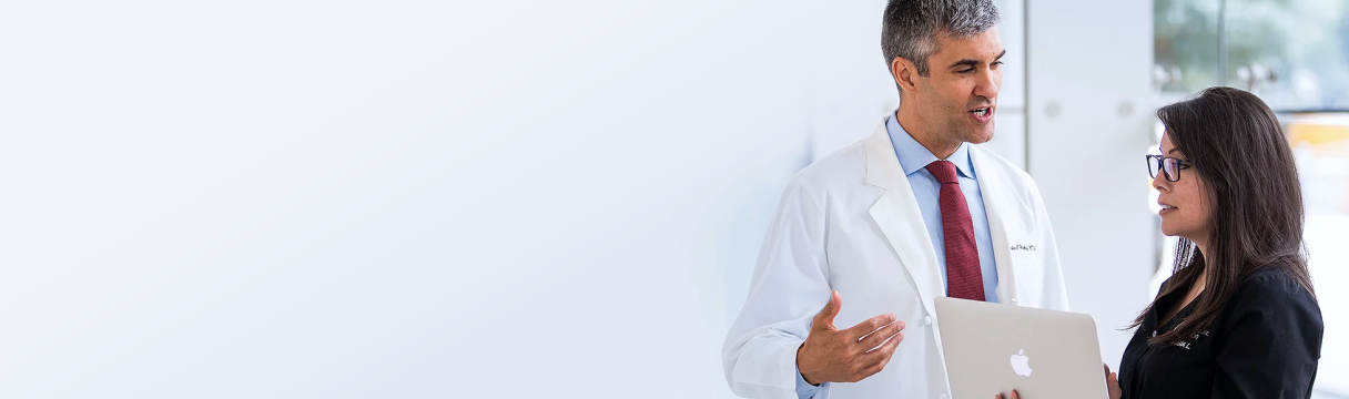 Doctor discussing reuslts on a laptop with a woman